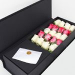 purple roses in a box