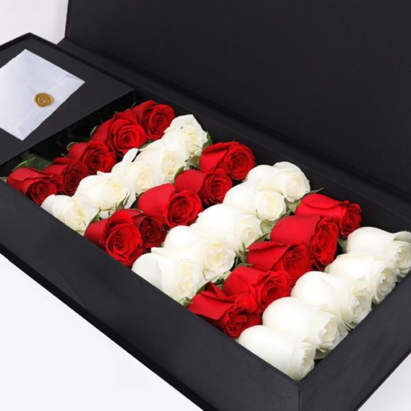 black box with red and white roses