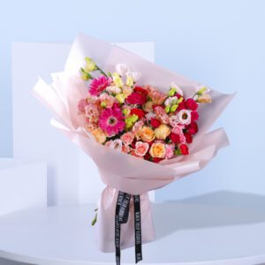 Peach and pink bouquet with Lisianthus, spray roses, carnations, and gerberas presents a beautiful blend for any occasion.