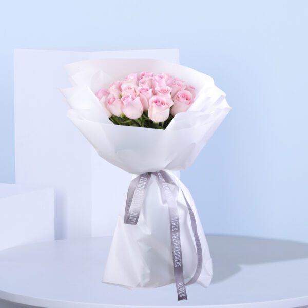 30 elegant pink roses wrapped beautifully in pink paper and adorned with a ribbon.